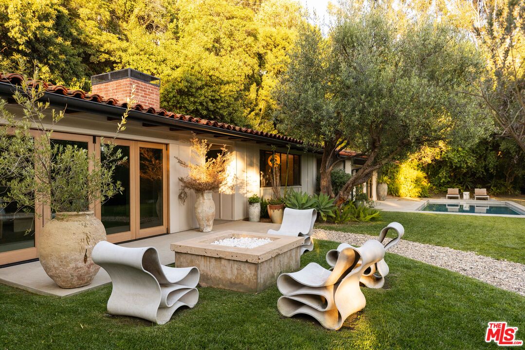 1830 Old Orchard Road Los Angeles, CA 90049 - Photo 1 of 30 a swimming pool with outdoor seating and yard