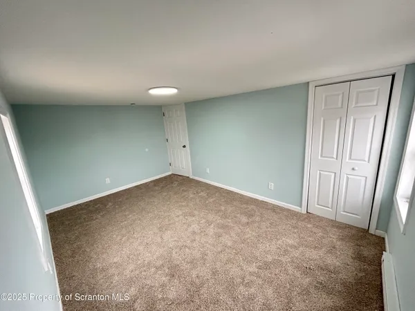 an empty room with a mirror