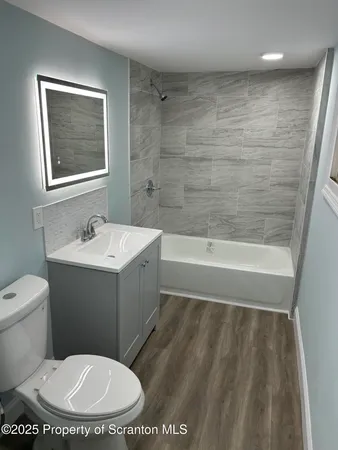 a bathroom with a toilet a sink and bathtub