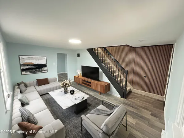 a living room with furniture and a wooden floor