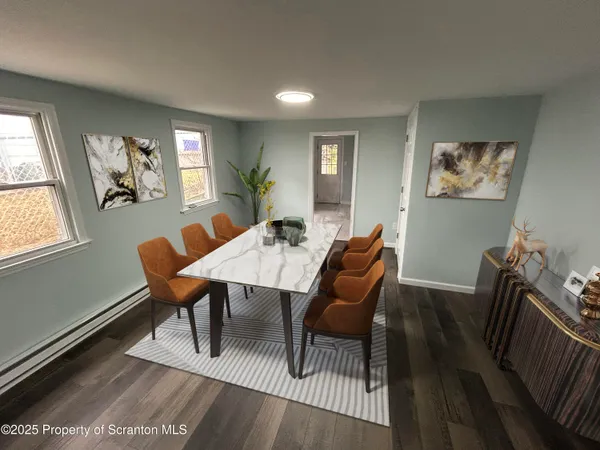 a dining room with furniture a rug and wooden floor