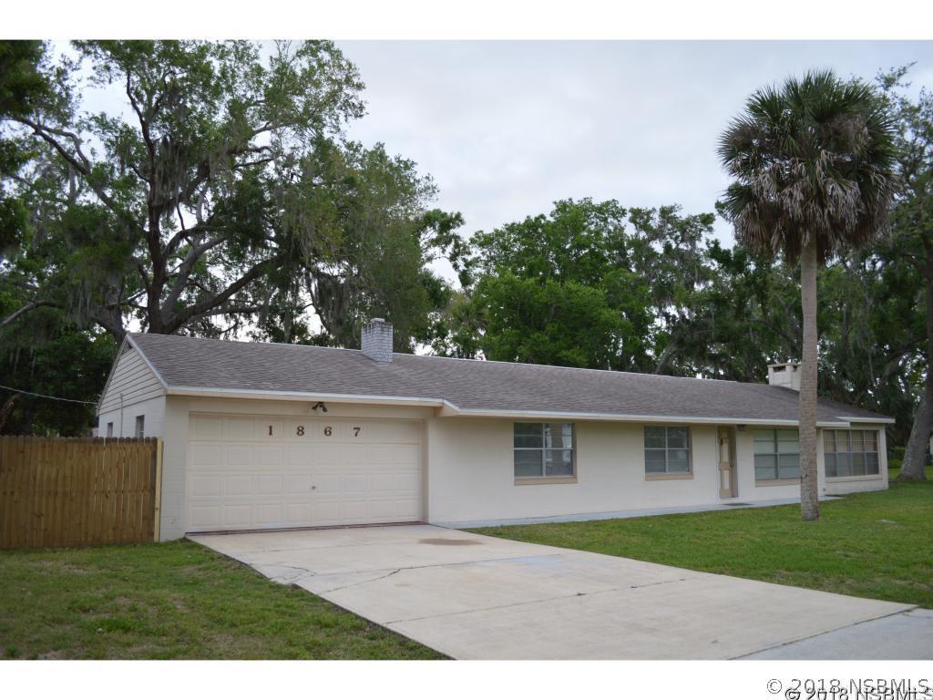 1867 Pine Tree Drive Edgewater, FL 32141 - Photo 1 of 10 a front view of a house with a garden