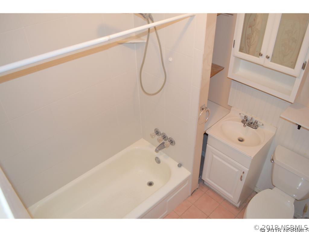 1867 Pine Tree Drive Edgewater, FL 32141 - Photo 3 of 10 a bathroom with a bath tub and a sink