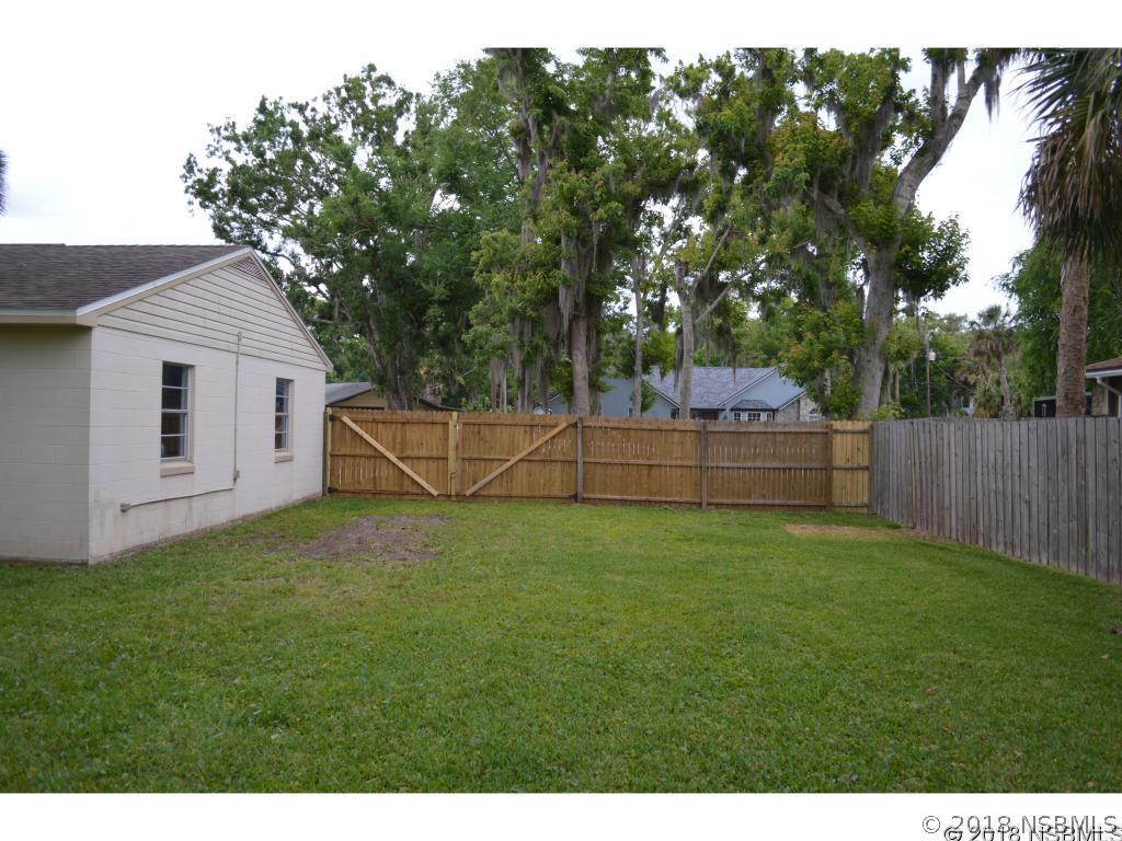 1867 Pine Tree Drive Edgewater, FL 32141 - Photo 8 of 10 a backyard of a house with lots of green space
