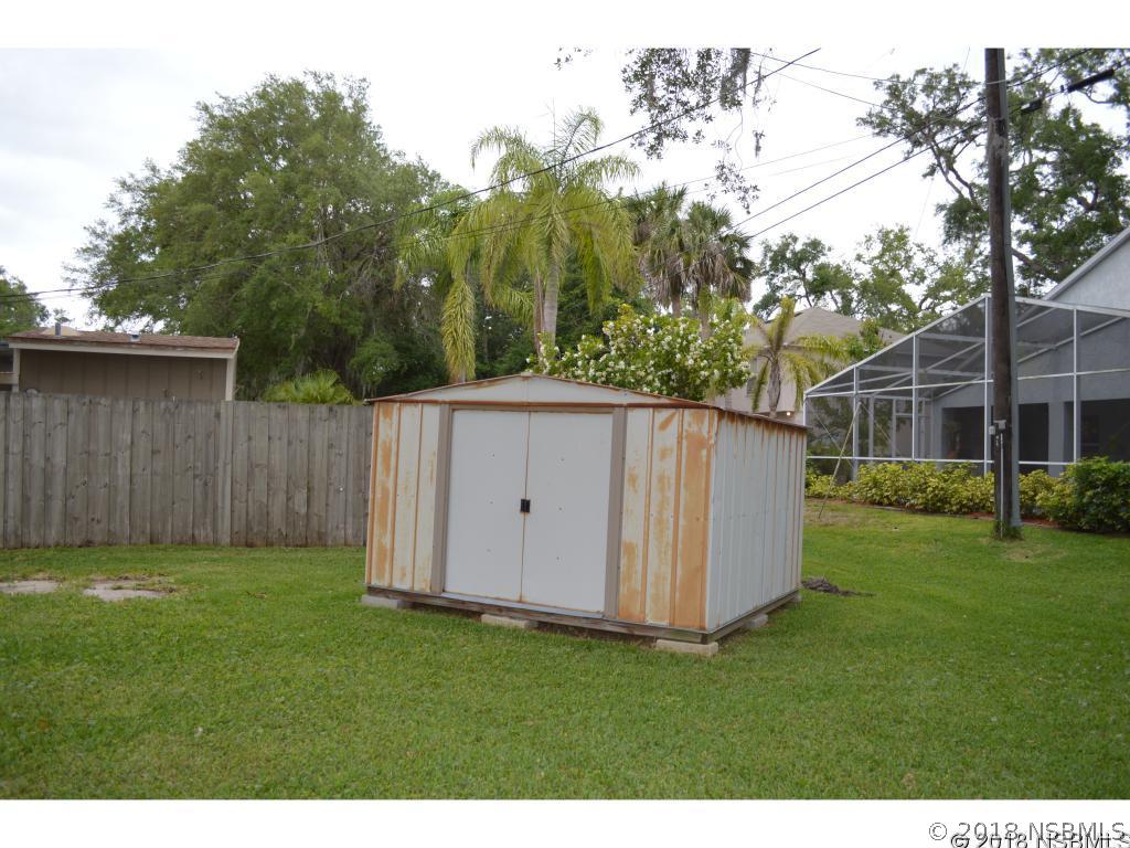 1867 Pine Tree Drive Edgewater, FL 32141 - Photo 10 of 10 a backyard of a house with lots of green space