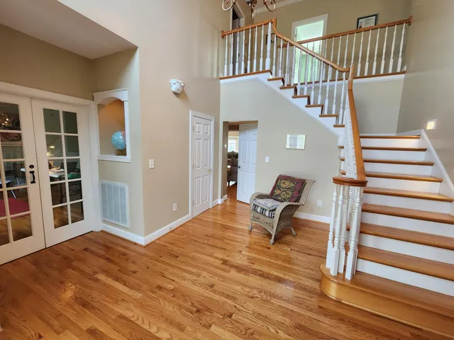 a view of entryway and hall with wooden floor