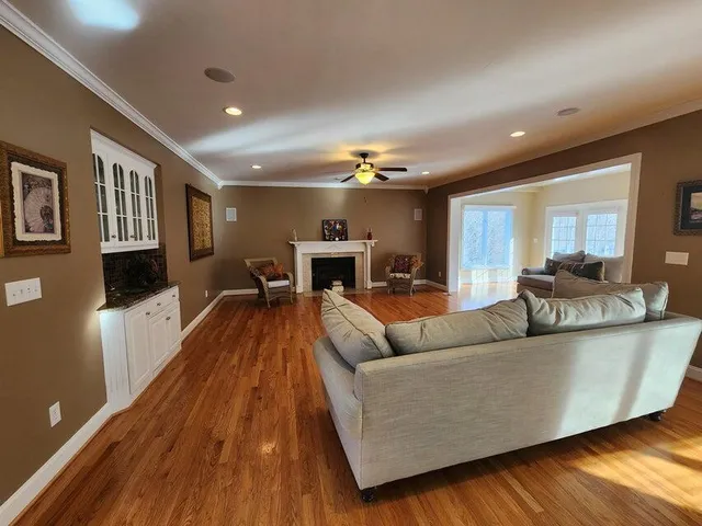 a living room with furniture and a wooden floor