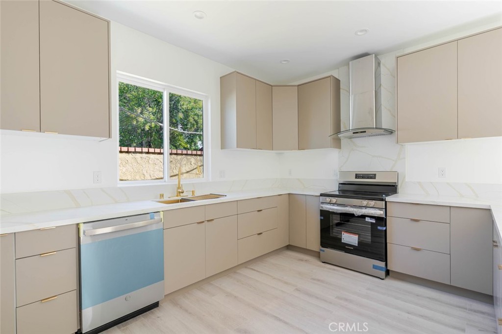 17426 Roscoe Boulevard Northridge, CA 91325 - Photo 11 of 28 a kitchen with a sink stove and cabinets