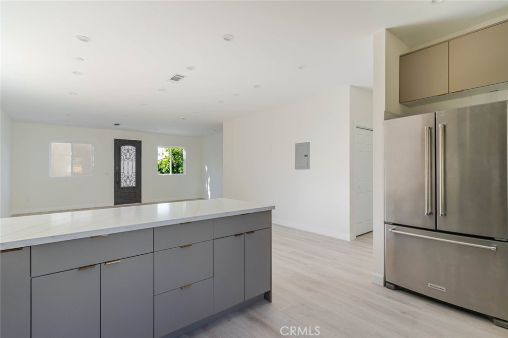 17426 Roscoe Boulevard Northridge, CA 91325 - Photo 13 of 28 a kitchen with a refrigerator and a sink