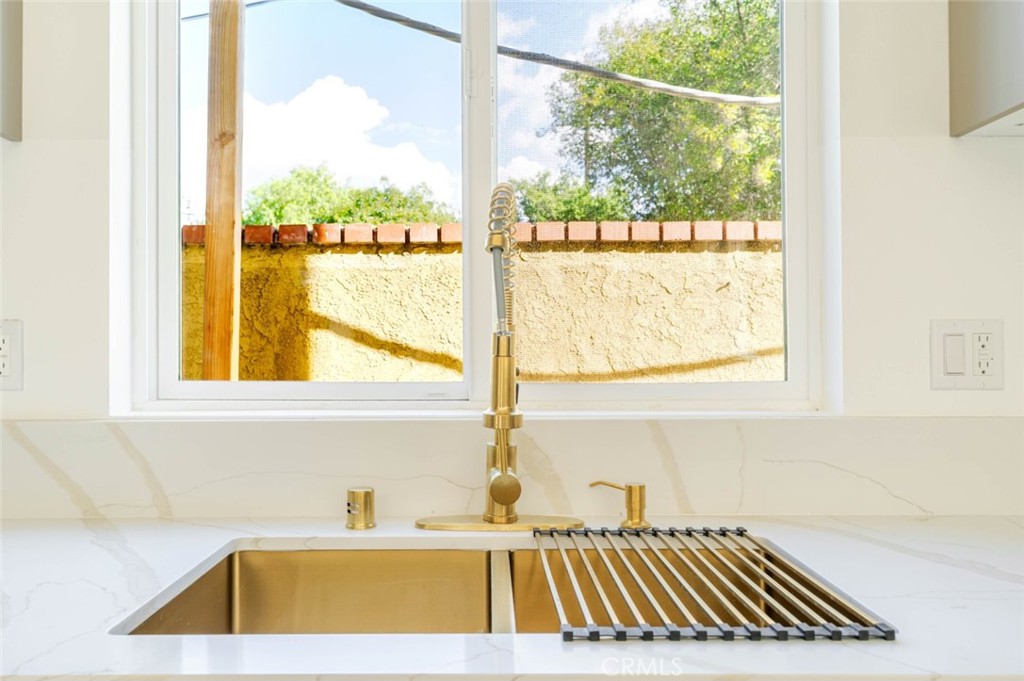 17426 Roscoe Boulevard Northridge, CA 91325 - Photo 14 of 28 a bathroom with a sink and a window
