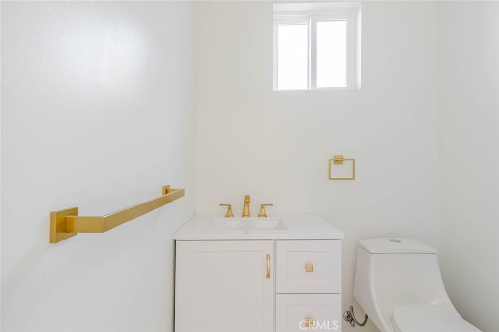 17426 Roscoe Boulevard Northridge, CA 91325 - Photo 16 of 28 a bathroom with a sink a toilet and a window