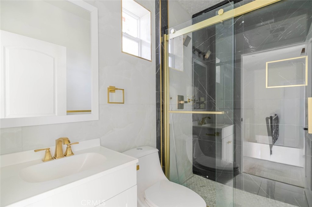 17426 Roscoe Boulevard Northridge, CA 91325 - Photo 17 of 28 a bathroom with a sink a toilet and shower