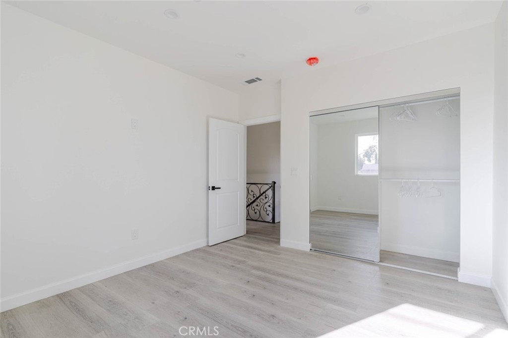 17426 Roscoe Boulevard Northridge, CA 91325 - Photo 19 of 28 a view of an empty room with window and wooden floor