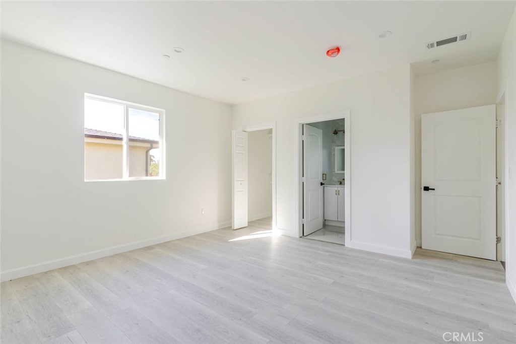 17426 Roscoe Boulevard Northridge, CA 91325 - Photo 23 of 28 a view of an empty room with wooden floor and a window