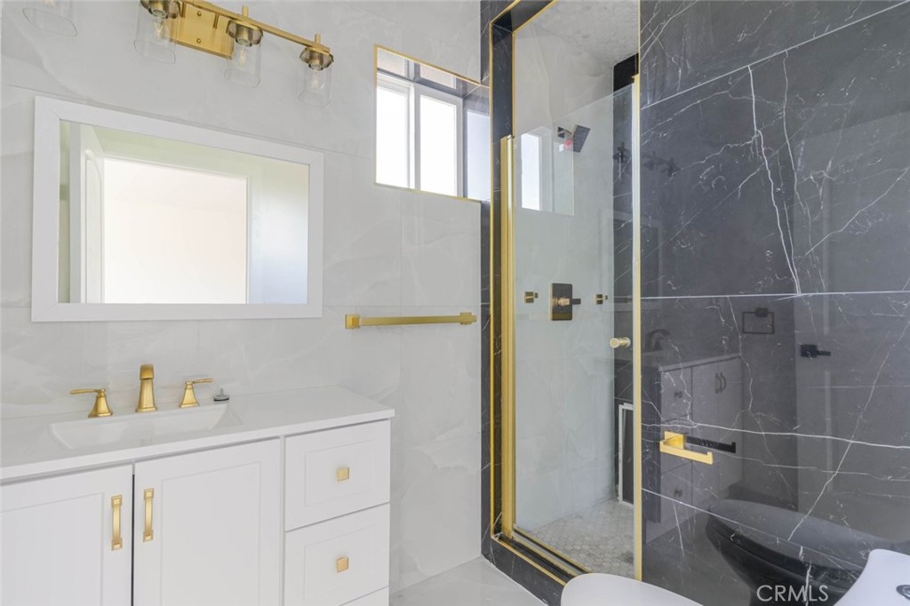 17426 Roscoe Boulevard Northridge, CA 91325 - Photo 25 of 28 a bathroom with a shower and a sink