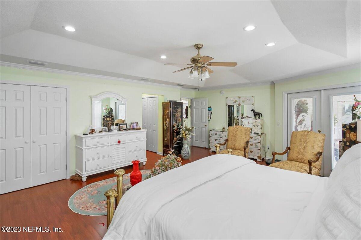 1233 Cactus Cut Road Middleburg, FL 32068 - Photo 17 of 46 a bed room with a bed and a chandelier
