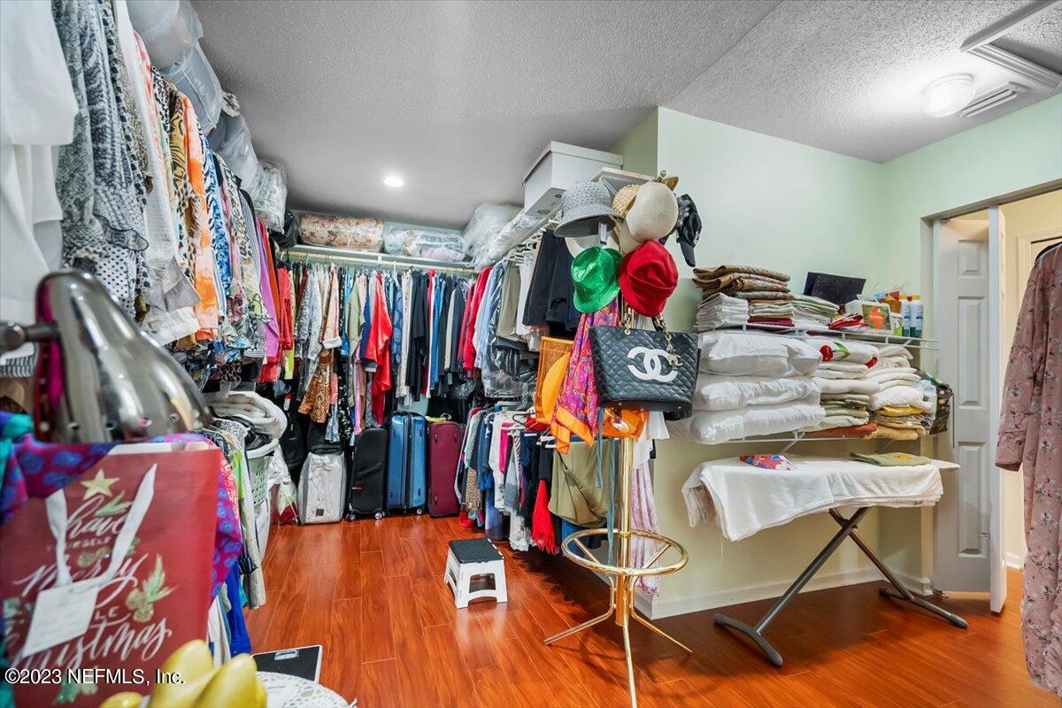 1233 Cactus Cut Road Middleburg, FL 32068 - Photo 18 of 46 a view of walk in closet with clothes and shoes