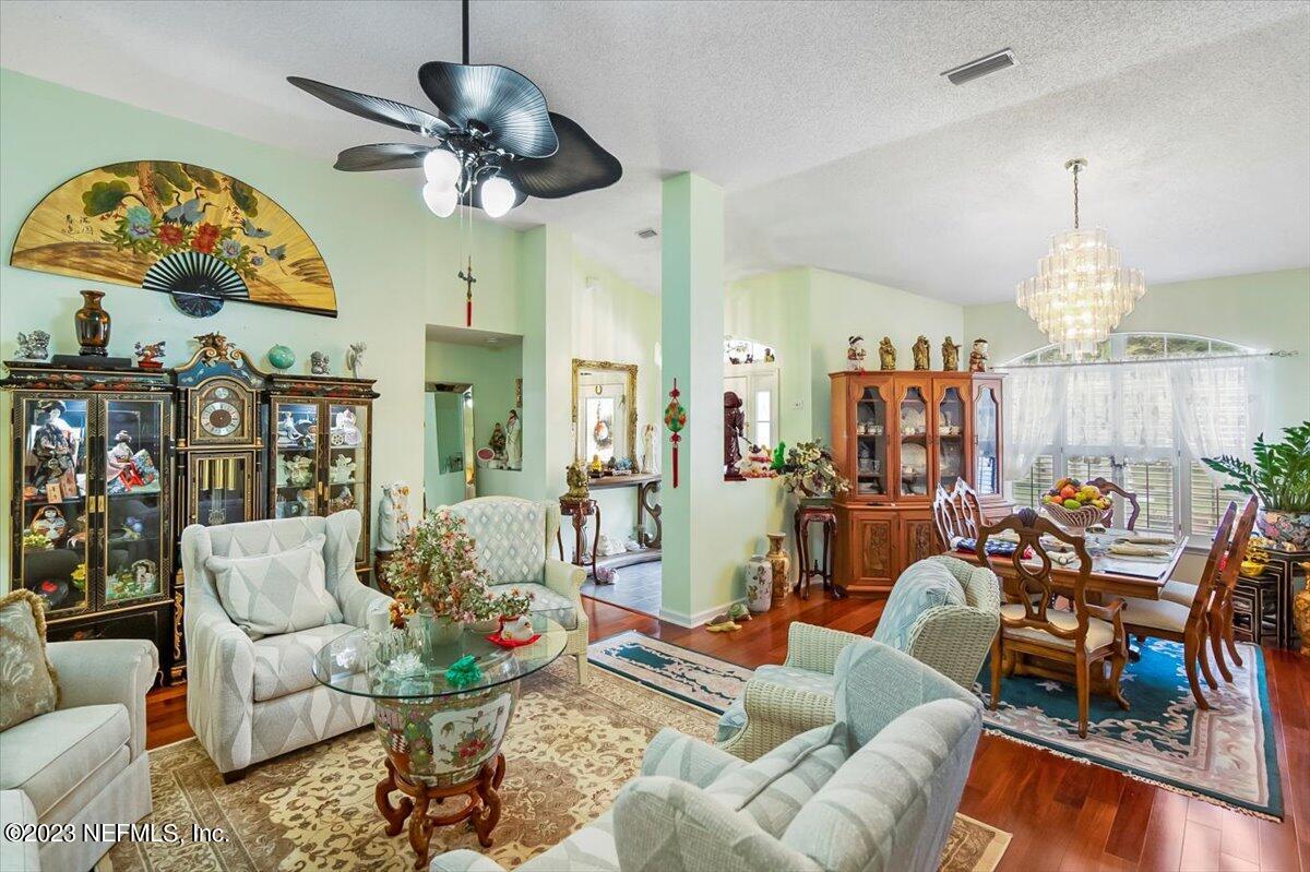 1233 Cactus Cut Road Middleburg, FL 32068 - Photo 22 of 46 a living room with furniture a dining table and a chandelier