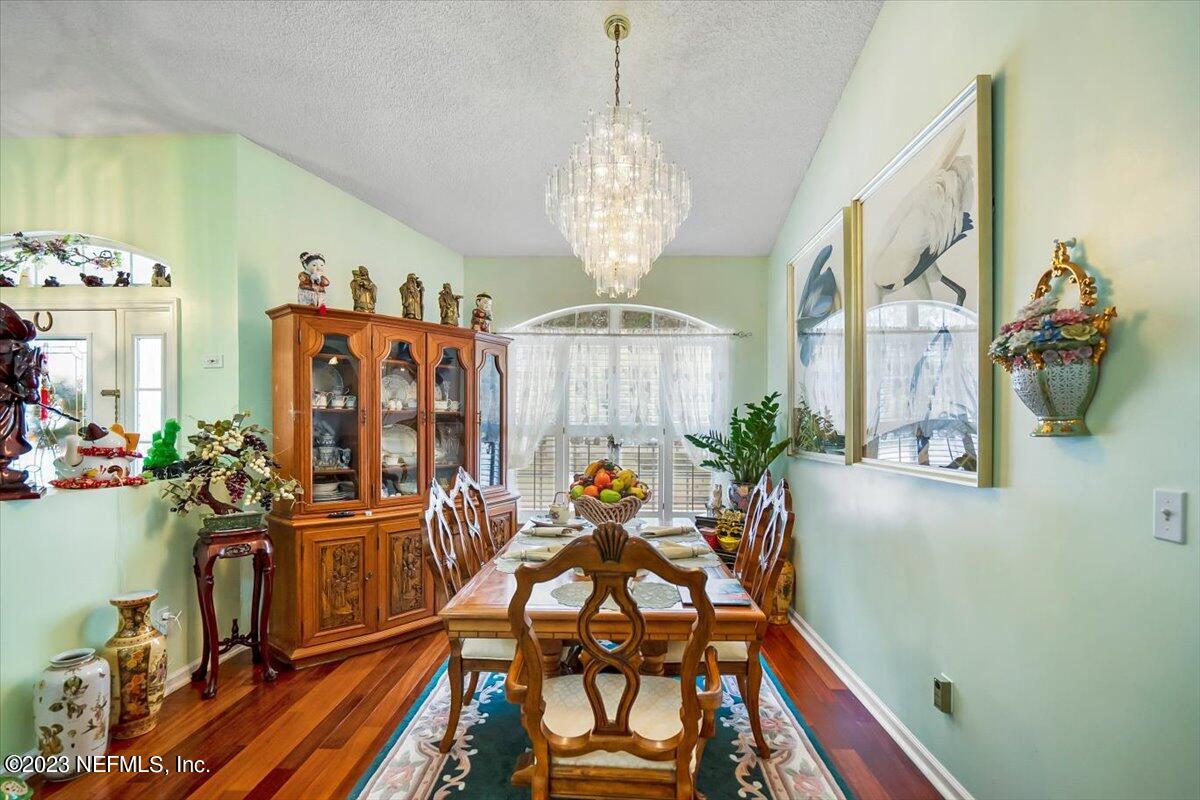 1233 Cactus Cut Road Middleburg, FL 32068 - Photo 25 of 46 a view of a dining room with furniture a chandelier and wooden floor