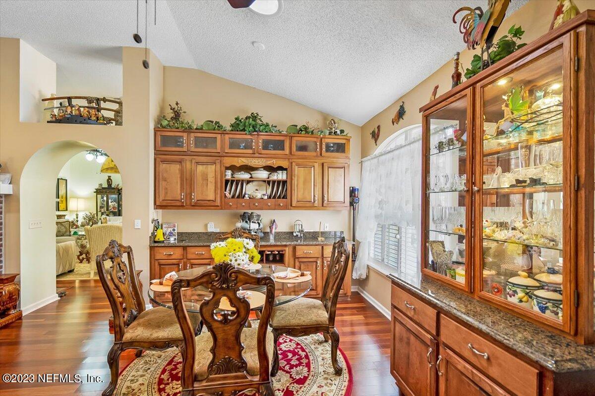 1233 Cactus Cut Road Middleburg, FL 32068 - Photo 28 of 46 a view of a dining room with furniture a chandelier and wooden floor