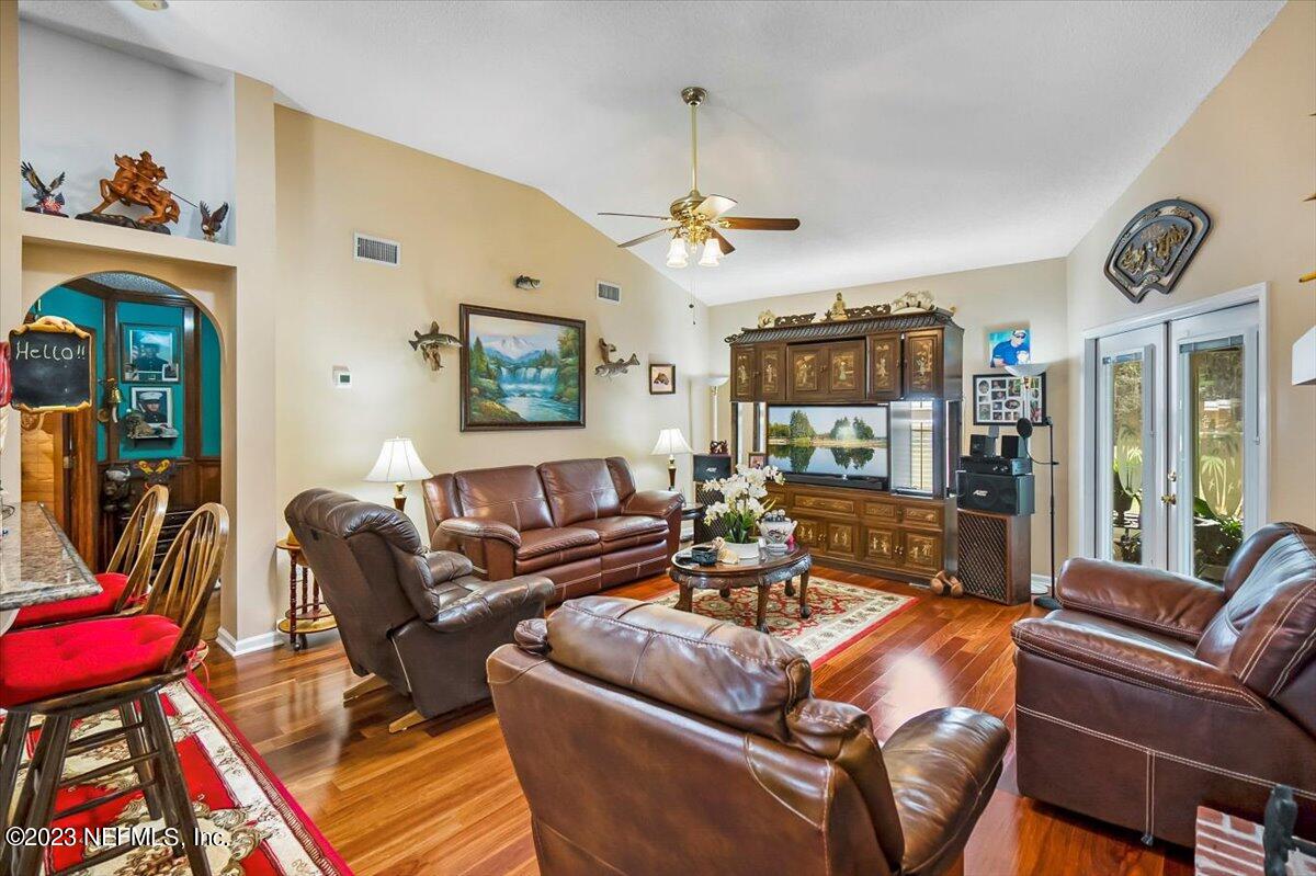 1233 Cactus Cut Road Middleburg, FL 32068 - Photo 33 of 46 a living room with furniture a wooden floor and chandelier