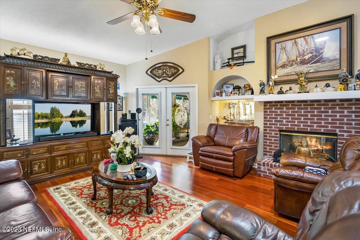 1233 Cactus Cut Road Middleburg, FL 32068 - Photo 34 of 46 a living room with furniture a flat screen tv and a fireplace