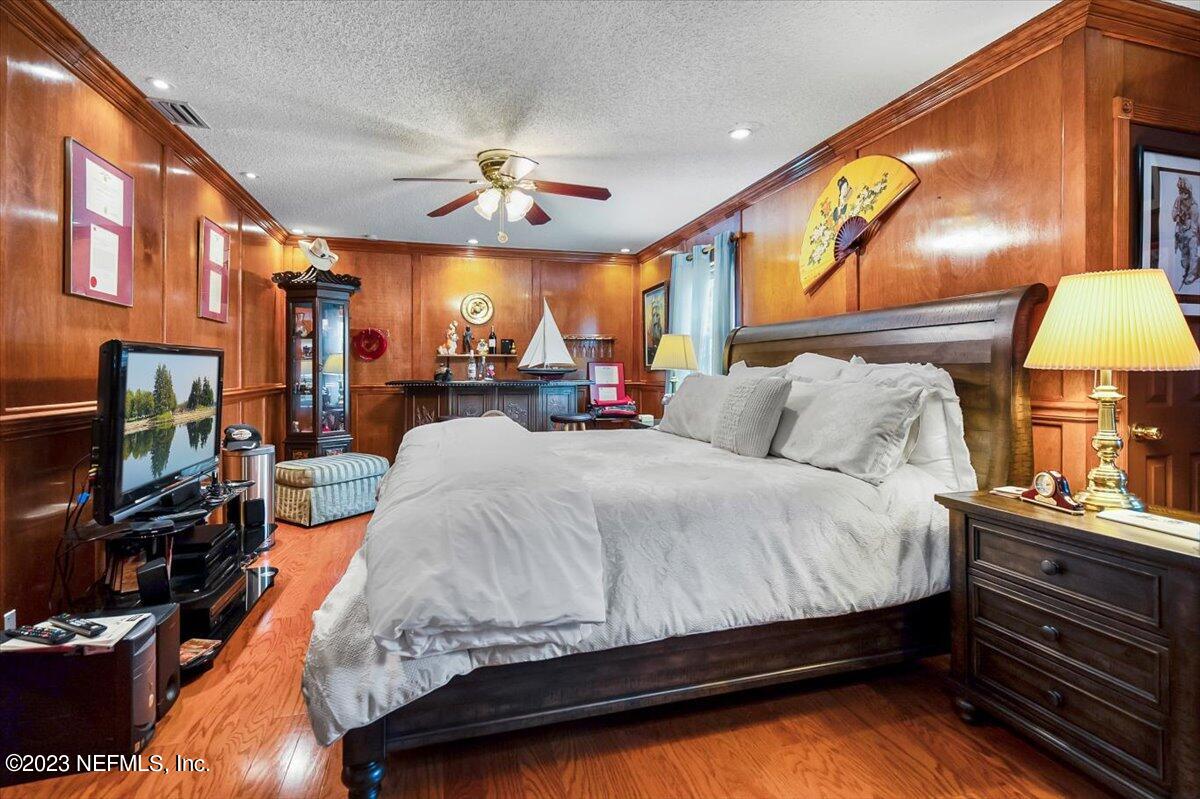 1233 Cactus Cut Road Middleburg, FL 32068 - Photo 36 of 46 a spacious bedroom with a bed and a flat tv screen on dresser