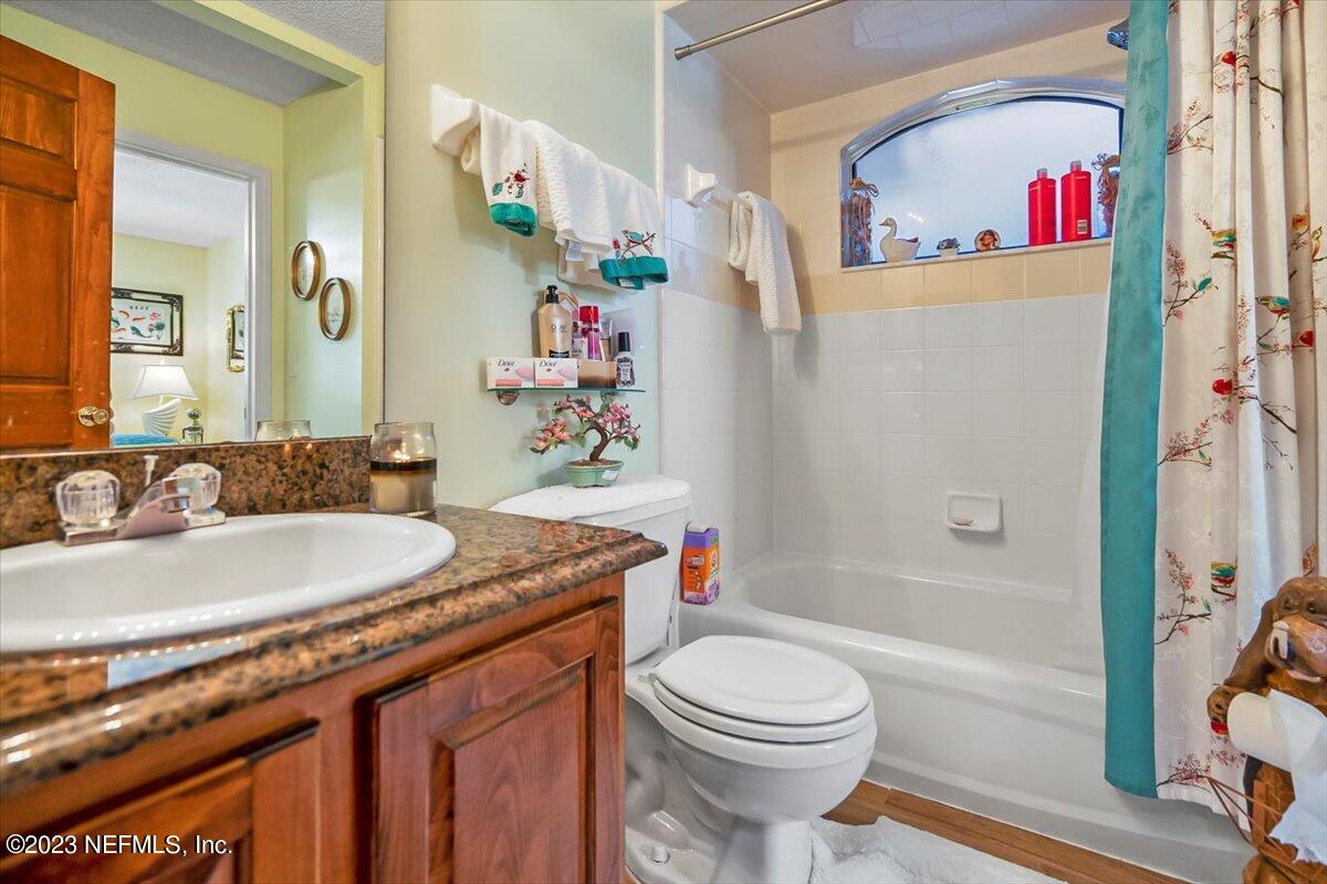 1233 Cactus Cut Road Middleburg, FL 32068 - Photo 38 of 46 a bathroom with a granite countertop sink a toilet and shower