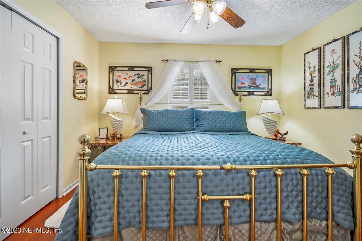 1233 Cactus Cut Road Middleburg, FL 32068 - Photo 39 of 46 a bedroom with a bed and wooden floor