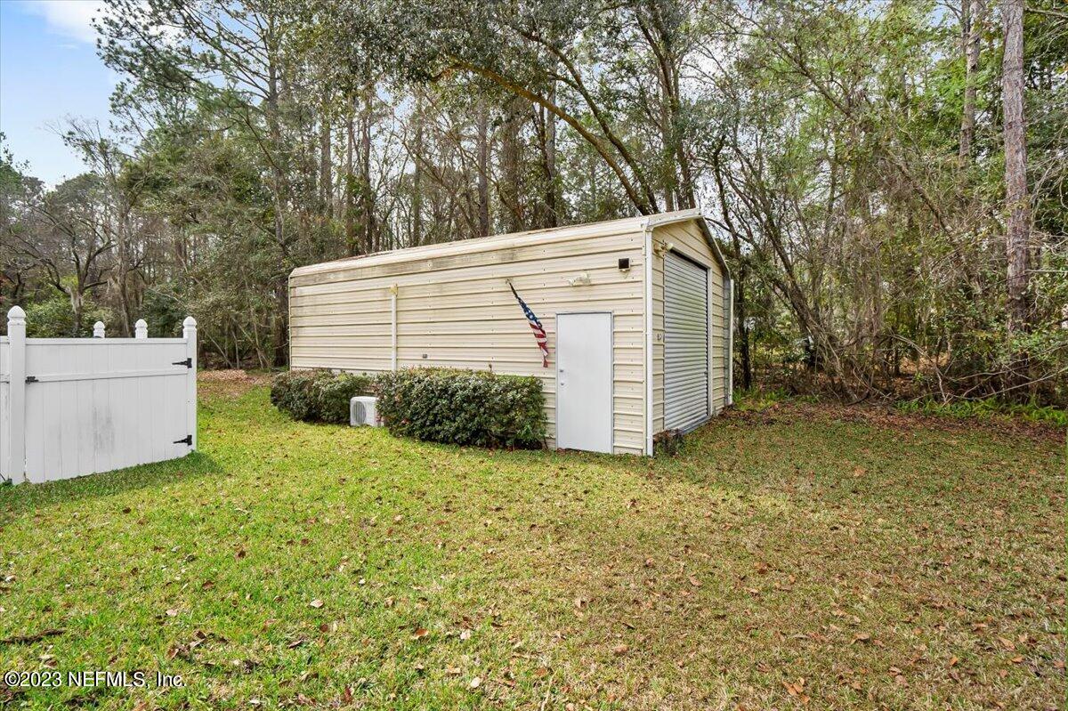 1233 Cactus Cut Road Middleburg, FL 32068 - Photo 42 of 46 a view of a house with a yard and large tree