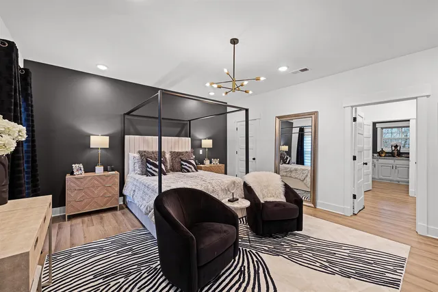 a living room with furniture a chandelier and a rug