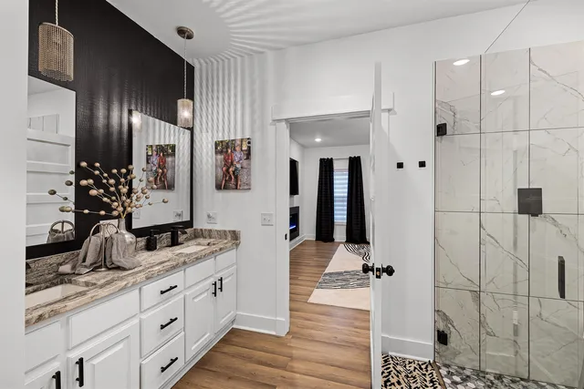 a bathroom with a double vanity sink and mirror