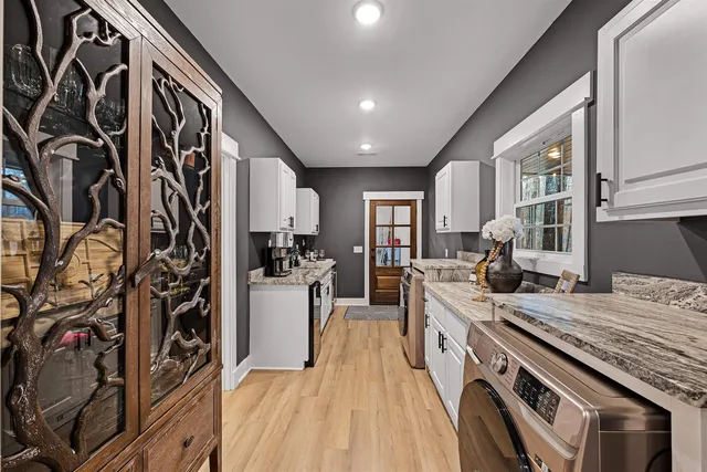 a kitchen with a sink stove and cabinets