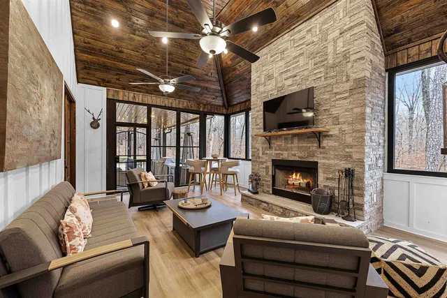 a living room with furniture a fireplace and a flat screen tv