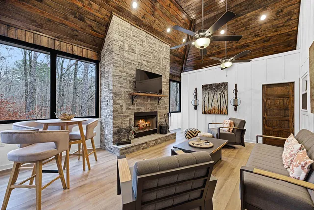a living room with furniture a fireplace and a flat screen tv
