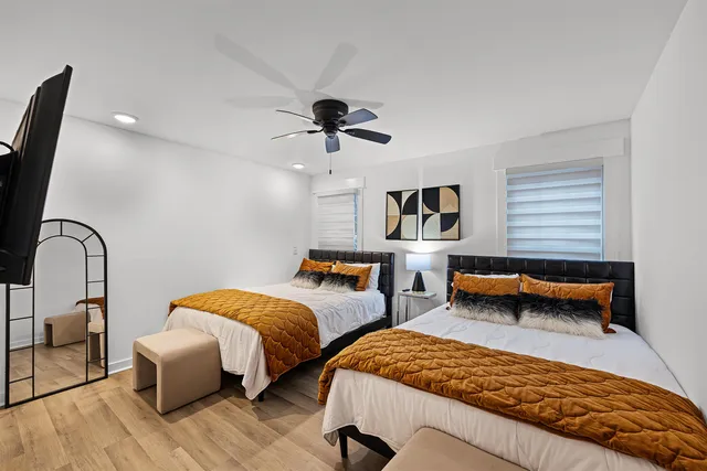 a bedroom with two beds and a chandelier