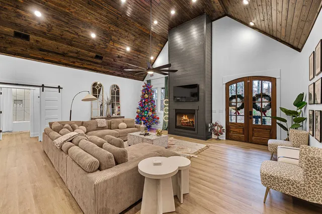 a living room with furniture a fireplace and wooden floor