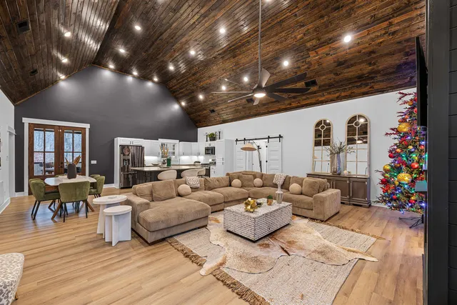 a living room with furniture and a chandelier