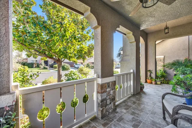 a view of a hallway with wooden floor and a living room