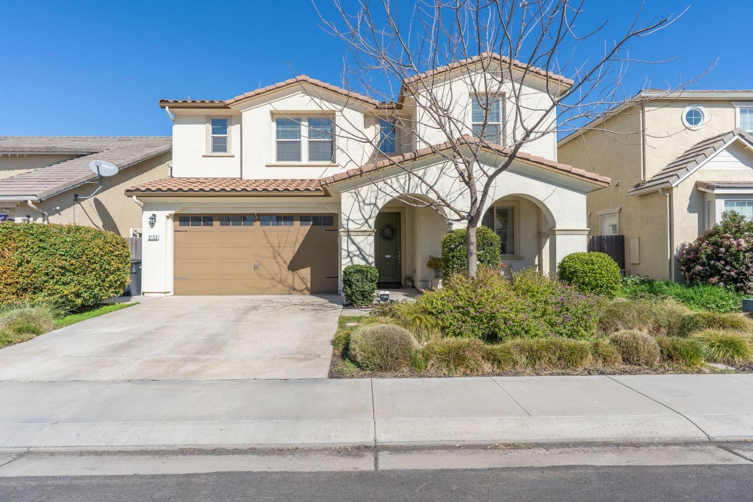 2153 Splendor Way Modesto, CA 95357 - Photo 1 of 1 a front view of a house with a garden