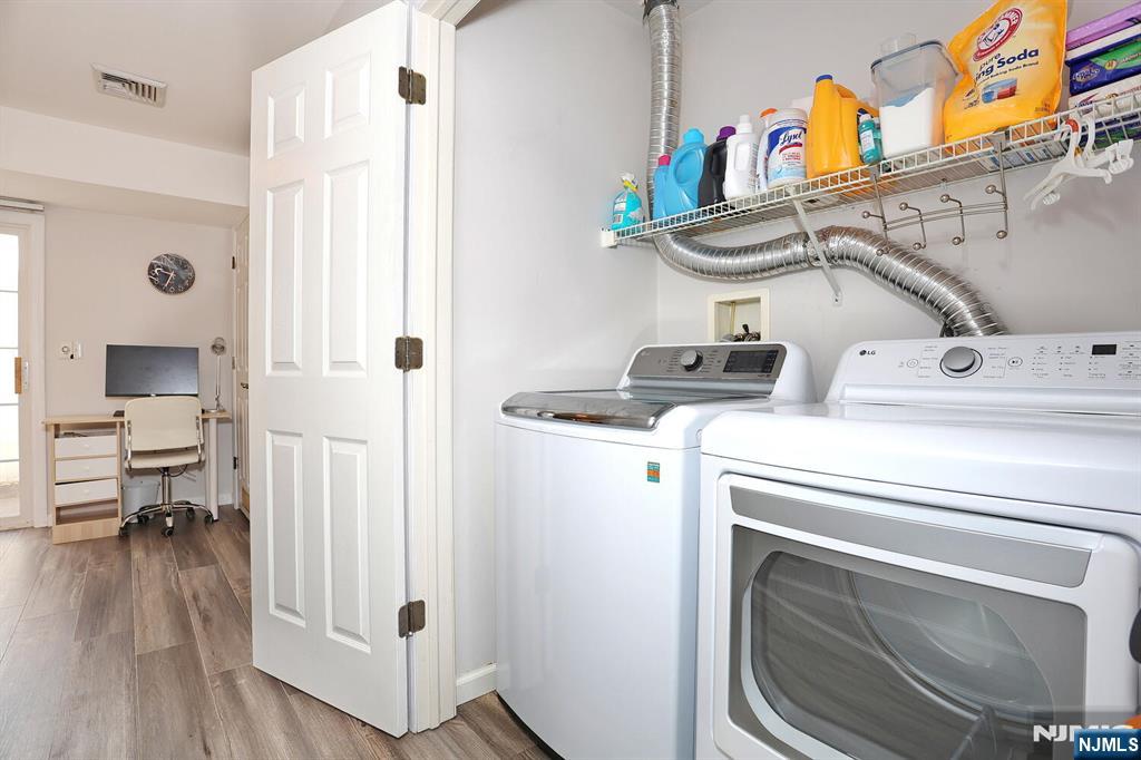 209 Union Street, Unit 4 Lodi, NJ 07644 - Photo 12 of 41 a view of washer and dryer with bathroom in the background
