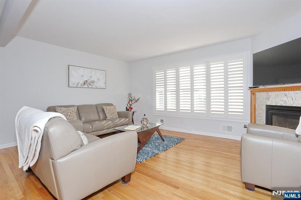 209 Union Street, Unit 4 Lodi, NJ 07644 - Photo 14 of 41 a living room with furniture a flat screen tv and a fireplace