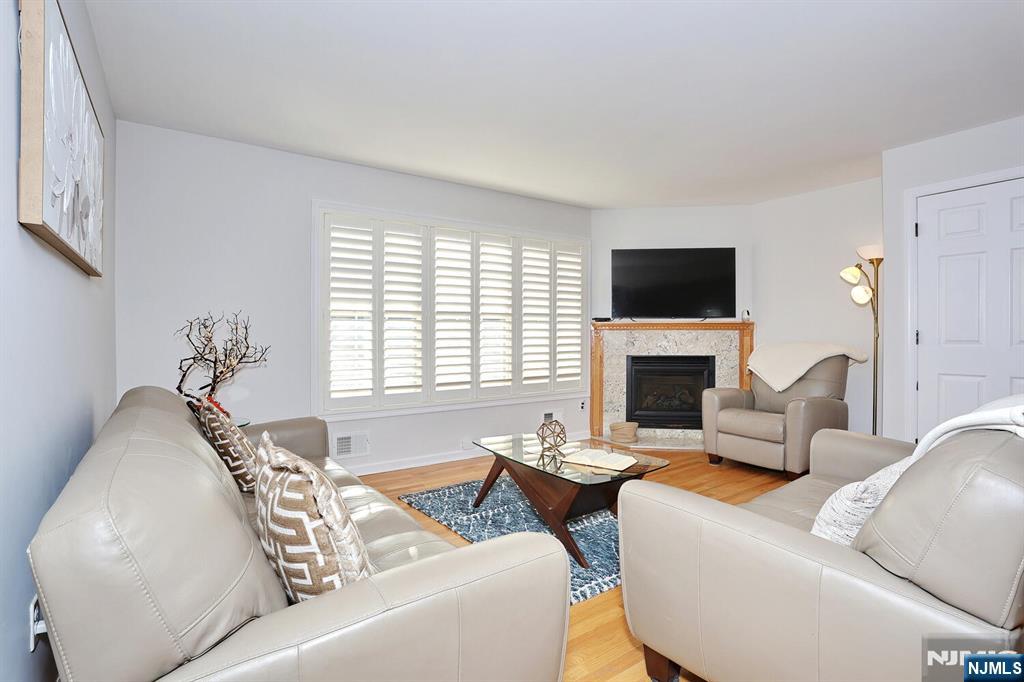 209 Union Street, Unit 4 Lodi, NJ 07644 - Photo 15 of 41 a living room with furniture a fireplace and a flat screen tv