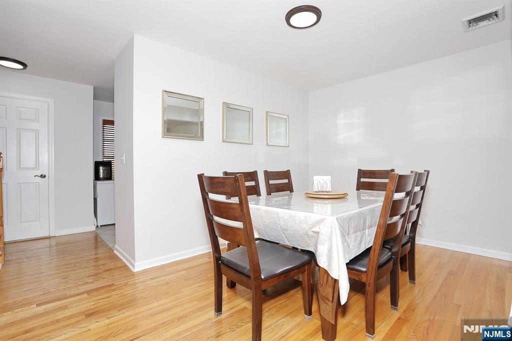 209 Union Street, Unit 4 Lodi, NJ 07644 - Photo 18 of 41 a view of a dining room with furniture and wooden floor