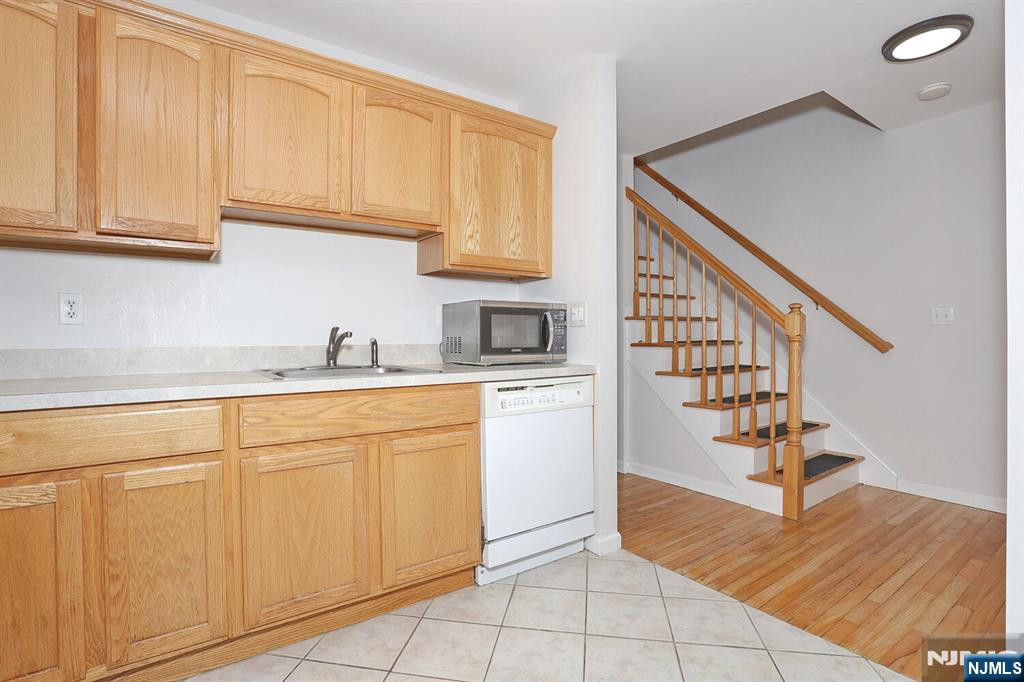 209 Union Street, Unit 4 Lodi, NJ 07644 - Photo 24 of 41 a kitchen with white cabinets and sink