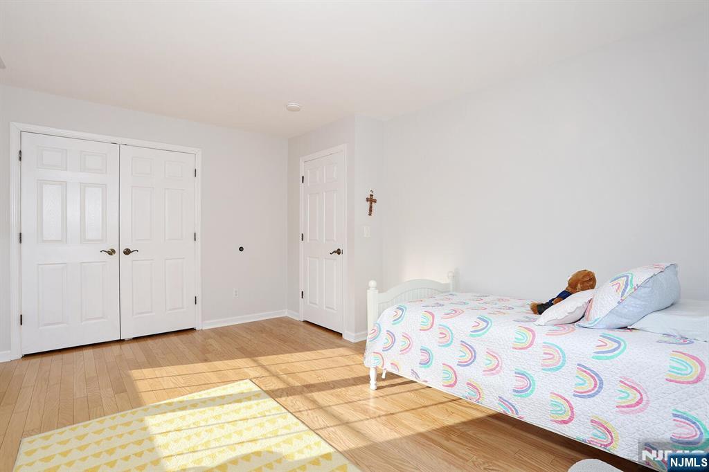 209 Union Street, Unit 4 Lodi, NJ 07644 - Photo 32 of 41 a bedroom with a bed and a painting on the wall