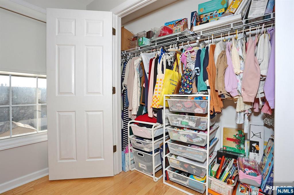 209 Union Street, Unit 4 Lodi, NJ 07644 - Photo 34 of 41 a view of walk in closet with clothes and shoes