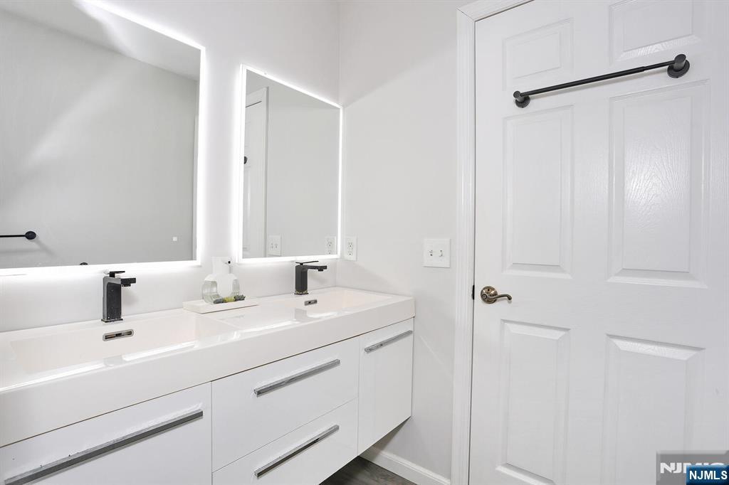 209 Union Street, Unit 4 Lodi, NJ 07644 - Photo 38 of 41 a bathroom with a sink and a mirror