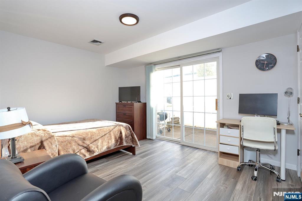 209 Union Street, Unit 4 Lodi, NJ 07644 - Photo 7 of 41 a bedroom with furniture and a flat screen tv