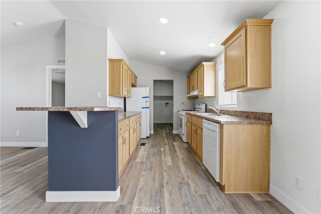 20843 Waalew Road, Unit C125 Apple Valley, CA 92307 - Photo 10 of 38 a kitchen with cabinets and wooden floor